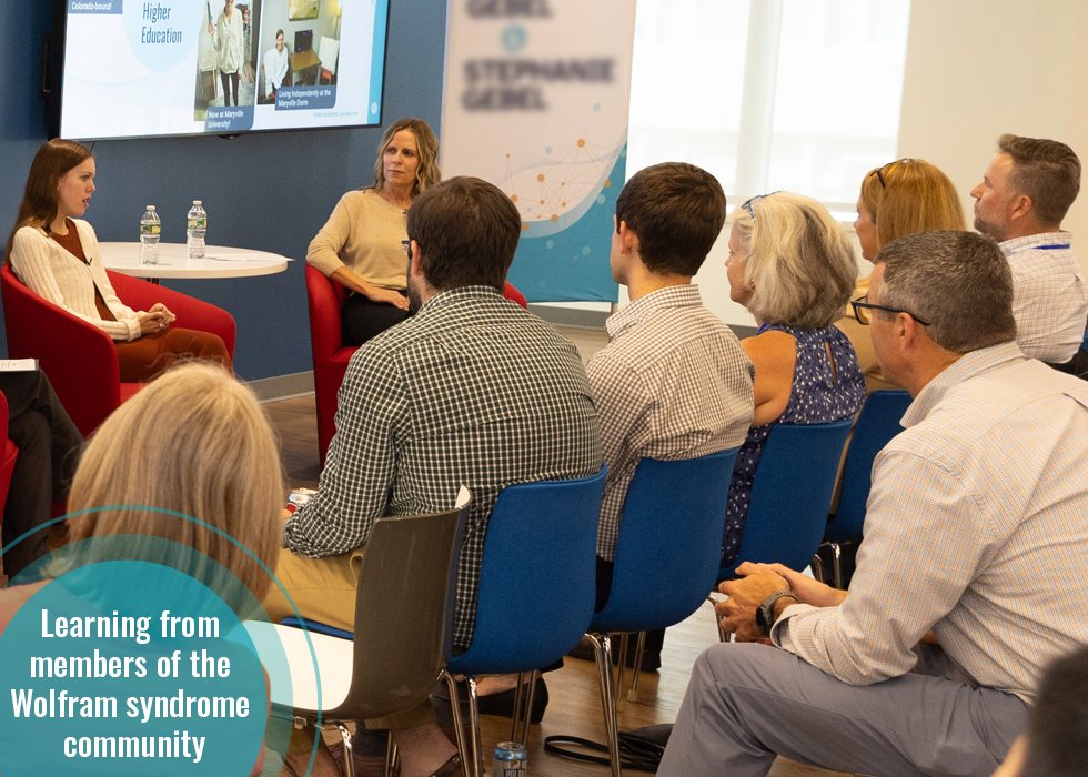 Two members of the Wolfram syndrome community speaking in front of an audience of Amylyx employees.