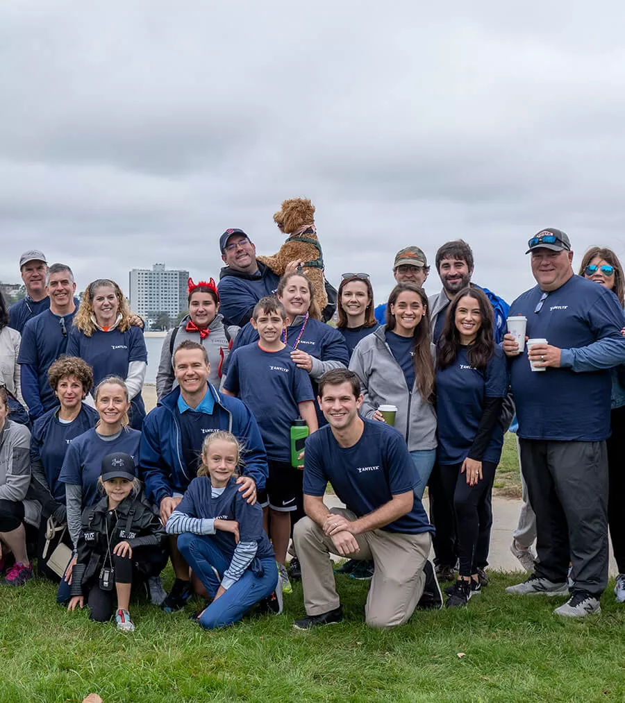 Group photo of Amylyx team smiling outdoors standing together